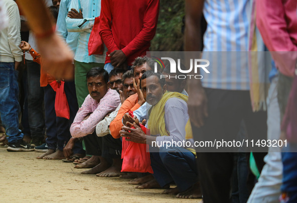 Hindu devotees are waiting in a long queue to pay their obeisance on the occasion of the Raksha Bandhan festival at the Shankaracharya templ...