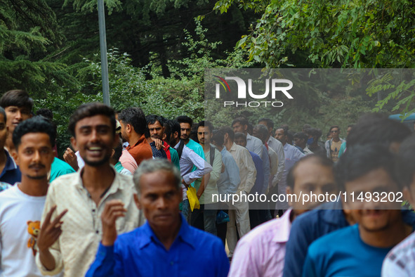 Hindu devotees are waiting in a long queue to pay their obeisance on the occasion of the Raksha Bandhan festival at the Shankaracharya templ...