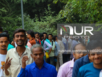 Hindu devotees are waiting in a long queue to pay their obeisance on the occasion of the Raksha Bandhan festival at the Shankaracharya templ...