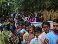 An Indian Paramilitary soldier is standing guard as Hindu devotees are arriving to pay obeisance on the occasion of the Raksha Bandhan festi...