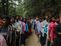 Hindu devotees are waiting in a long queue to pay their obeisance on the occasion of the Raksha Bandhan festival at the Shankaracharya templ...