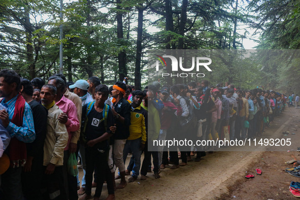 Hindu devotees are waiting in a long queue to pay their obeisance on the occasion of the Raksha Bandhan festival at the Shankaracharya templ...