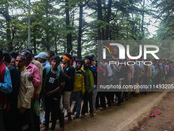 Hindu devotees are waiting in a long queue to pay their obeisance on the occasion of the Raksha Bandhan festival at the Shankaracharya templ...