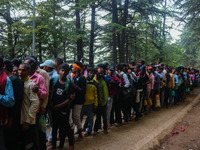 Hindu devotees are waiting in a long queue to pay their obeisance on the occasion of the Raksha Bandhan festival at the Shankaracharya templ...