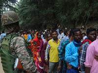 An Indian Paramilitary soldier is standing guard as Hindu devotees are arriving to pay obeisance on the occasion of the Raksha Bandhan festi...