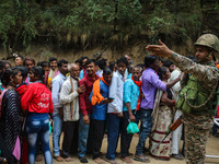 An Indian Paramilitary soldier is standing guard as Hindu devotees are arriving to pay obeisance on the occasion of the Raksha Bandhan festi...