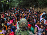 An Indian Paramilitary soldier is standing guard as Hindu devotees are arriving to pay obeisance on the occasion of the Raksha Bandhan festi...