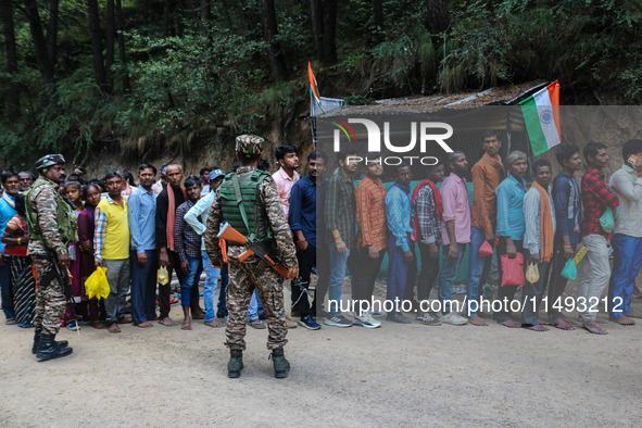 Indian Paramilitary soldiers are standing guard as Hindu devotees are arriving to pay obeisance on the occasion of the Raksha Bandhan festiv...