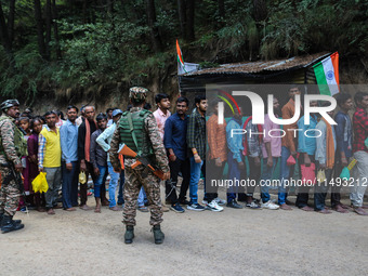 Indian Paramilitary soldiers are standing guard as Hindu devotees are arriving to pay obeisance on the occasion of the Raksha Bandhan festiv...