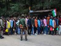 Indian Paramilitary soldiers are standing guard as Hindu devotees are arriving to pay obeisance on the occasion of the Raksha Bandhan festiv...