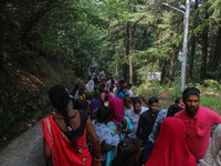 Hindu devotees are waiting in a long queue to pay their obeisance on the occasion of the Raksha Bandhan festival at the Shankaracharya templ...