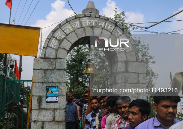 A Hindu devotee is ringing a traditional bell on the occasion of the Raksha Bandhan festival at the Shankaracharya temple in Srinagar, Jammu...