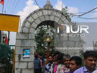 A Hindu devotee is ringing a traditional bell on the occasion of the Raksha Bandhan festival at the Shankaracharya temple in Srinagar, Jammu...