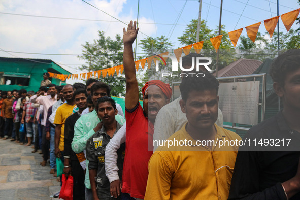 Hindu devotees are waiting in a long queue to pay their obeisance on the occasion of the Raksha Bandhan festival at the Shankaracharya templ...