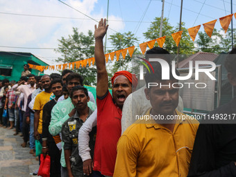 Hindu devotees are waiting in a long queue to pay their obeisance on the occasion of the Raksha Bandhan festival at the Shankaracharya templ...