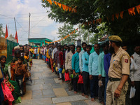 An Indian policeman is standing guard as Hindu devotees are arriving to pay obeisance on the occasion of the Raksha Bandhan festival at the...