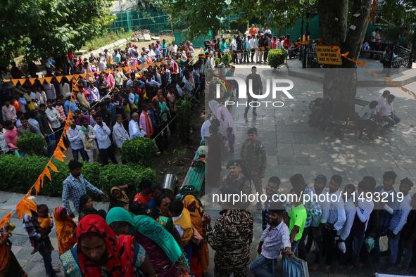 Hindu devotees are waiting in a long queue to pay their obeisance on the occasion of the Raksha Bandhan festival at the Shankaracharya templ...