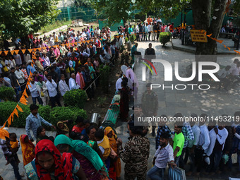 Hindu devotees are waiting in a long queue to pay their obeisance on the occasion of the Raksha Bandhan festival at the Shankaracharya templ...