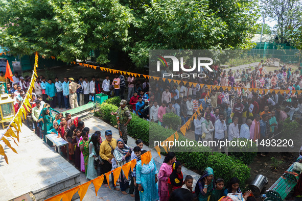 Hindu devotees are waiting in a long queue to pay their obeisance on the occasion of the Raksha Bandhan festival at the Shankaracharya templ...