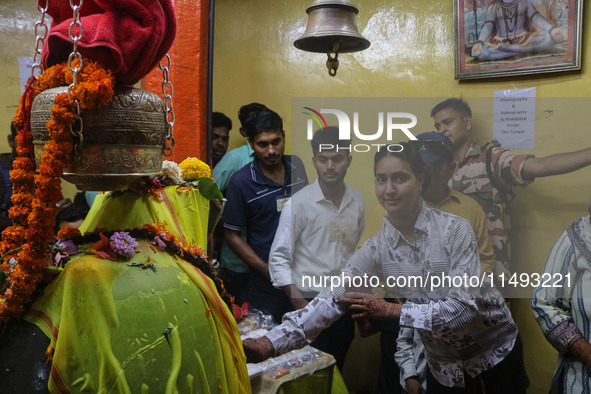 Hindu devotees are paying their obeisance on the occasion of the Raksha Bandhan festival at the Shankaracharya temple in Srinagar, Jammu and...