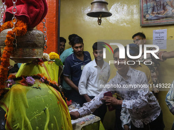 Hindu devotees are paying their obeisance on the occasion of the Raksha Bandhan festival at the Shankaracharya temple in Srinagar, Jammu and...