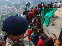 An Indian Paramilitary soldier is standing guard as Hindu devotees are arriving to pay obeisance on the occasion of the Raksha Bandhan festi...