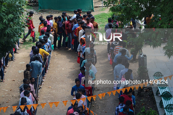 Hindu devotees are waiting in a long queue to pay their obeisance on the occasion of the Raksha Bandhan festival at the Shankaracharya templ...