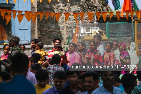 Hindu devotees are waiting in a long queue to pay their obeisance on the occasion of the Raksha Bandhan festival at the Shankaracharya templ...