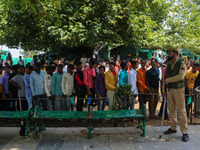 An Indian policeman is standing guard as Hindu devotees are arriving to pay obeisance on the occasion of the Raksha Bandhan festival at the...