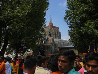 Hindu devotees are waiting in a long queue to pay their obeisance on the occasion of the Raksha Bandhan festival at the Shankaracharya templ...