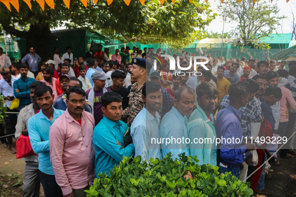 Hindu devotees are waiting in a long queue to pay their obeisance on the occasion of the Raksha Bandhan festival at the Shankaracharya templ...