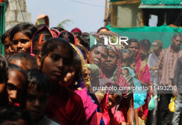 Hindu devotees are waiting in a long queue to pay their obeisance on the occasion of the Raksha Bandhan festival at the Shankaracharya templ...