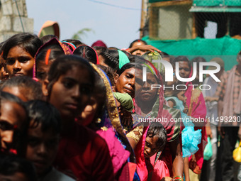 Hindu devotees are waiting in a long queue to pay their obeisance on the occasion of the Raksha Bandhan festival at the Shankaracharya templ...