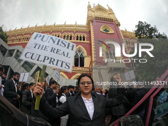 Lawyers of Calcutta High Court are holding posters and participating in a protest rally against the alleged sexual assault and murder of a p...