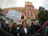 Lawyers of Calcutta High Court are holding posters and participating in a protest rally against the alleged sexual assault and murder of a p...