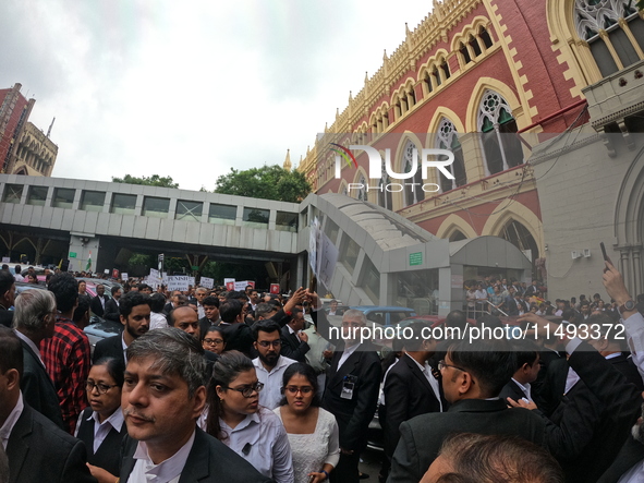 Lawyers of Calcutta High Court are holding posters and participating in a protest rally against the alleged sexual assault and murder of a p...