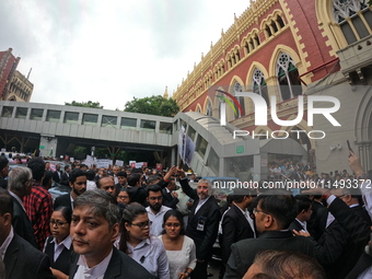 Lawyers of Calcutta High Court are holding posters and participating in a protest rally against the alleged sexual assault and murder of a p...