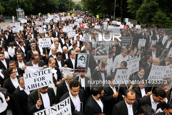 Lawyers of Calcutta High Court are holding posters and participating in a protest rally against the alleged sexual assault and murder of a p...