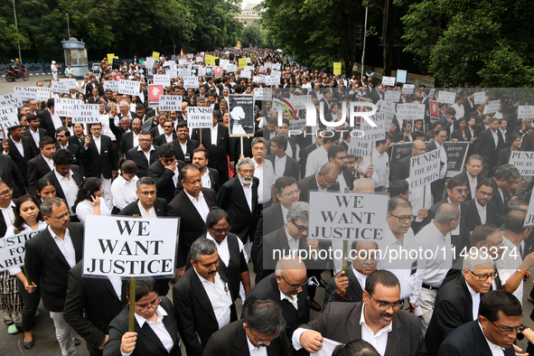 Lawyers of Calcutta High Court are holding posters and participating in a protest rally against the alleged sexual assault and murder of a p...