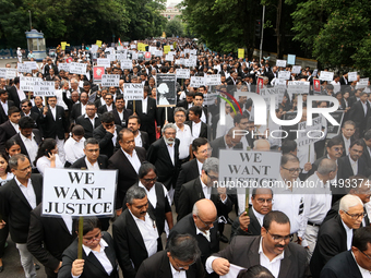 Lawyers of Calcutta High Court are holding posters and participating in a protest rally against the alleged sexual assault and murder of a p...