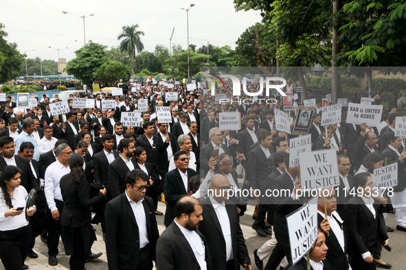 Lawyers of Calcutta High Court are holding posters and participating in a protest rally against the alleged sexual assault and murder of a p...