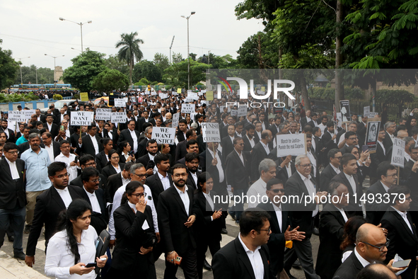 Lawyers of Calcutta High Court are holding posters and participating in a protest rally against the alleged sexual assault and murder of a p...