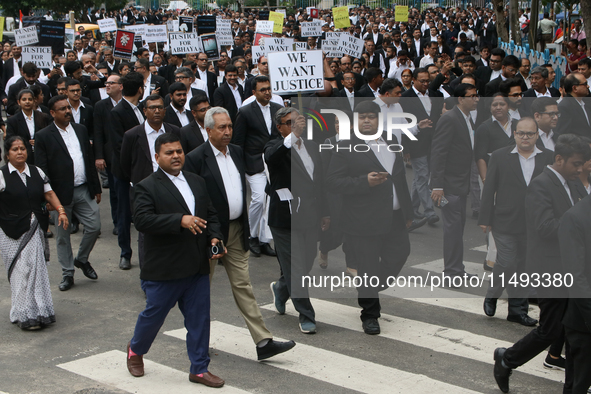 Lawyers of Calcutta High Court are holding posters and participating in a protest rally against the alleged sexual assault and murder of a p...