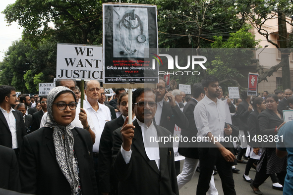 Lawyers of Calcutta High Court are holding posters and participating in a protest rally against the alleged sexual assault and murder of a p...