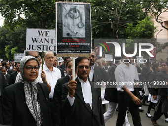 Lawyers of Calcutta High Court are holding posters and participating in a protest rally against the alleged sexual assault and murder of a p...