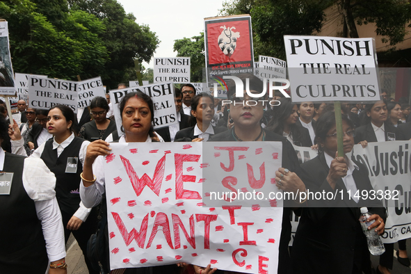 Lawyers of Calcutta High Court are holding posters and participating in a protest rally against the alleged sexual assault and murder of a p...