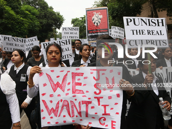 Lawyers of Calcutta High Court are holding posters and participating in a protest rally against the alleged sexual assault and murder of a p...