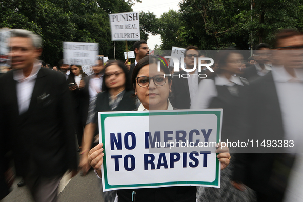 Lawyers of Calcutta High Court are holding posters and participating in a protest rally against the alleged sexual assault and murder of a p...