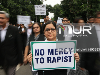 Lawyers of Calcutta High Court are holding posters and participating in a protest rally against the alleged sexual assault and murder of a p...