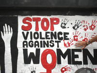 A doctor is painting a mural with his hand with slogans inside Kolkata Medical College and Hospital campus condemning the rape and murder of...